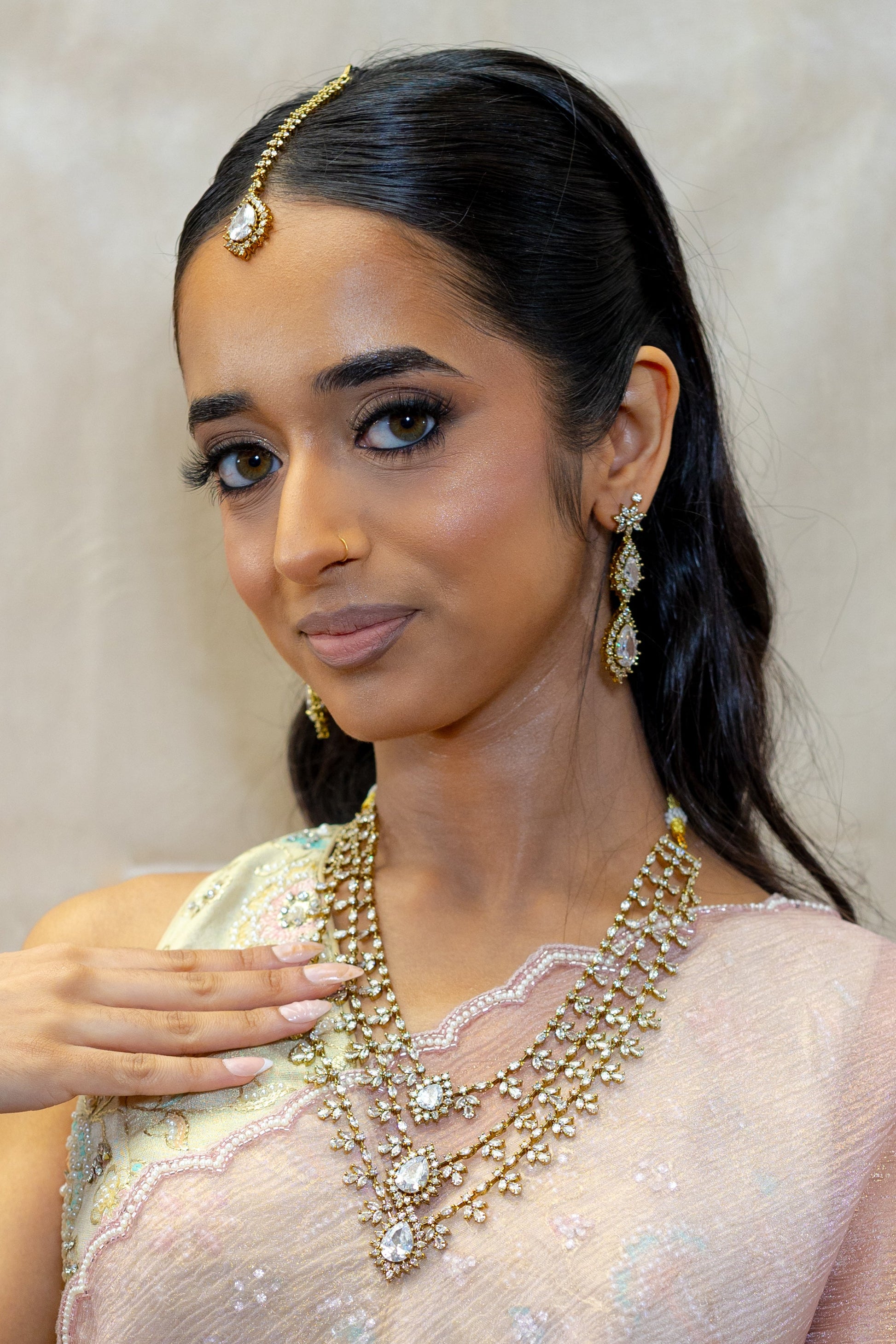 Close-up of Rani Crystal Floral motifs against Pink Saree fabric — Sophisticated wedding guest jewellery for festive celebrations.