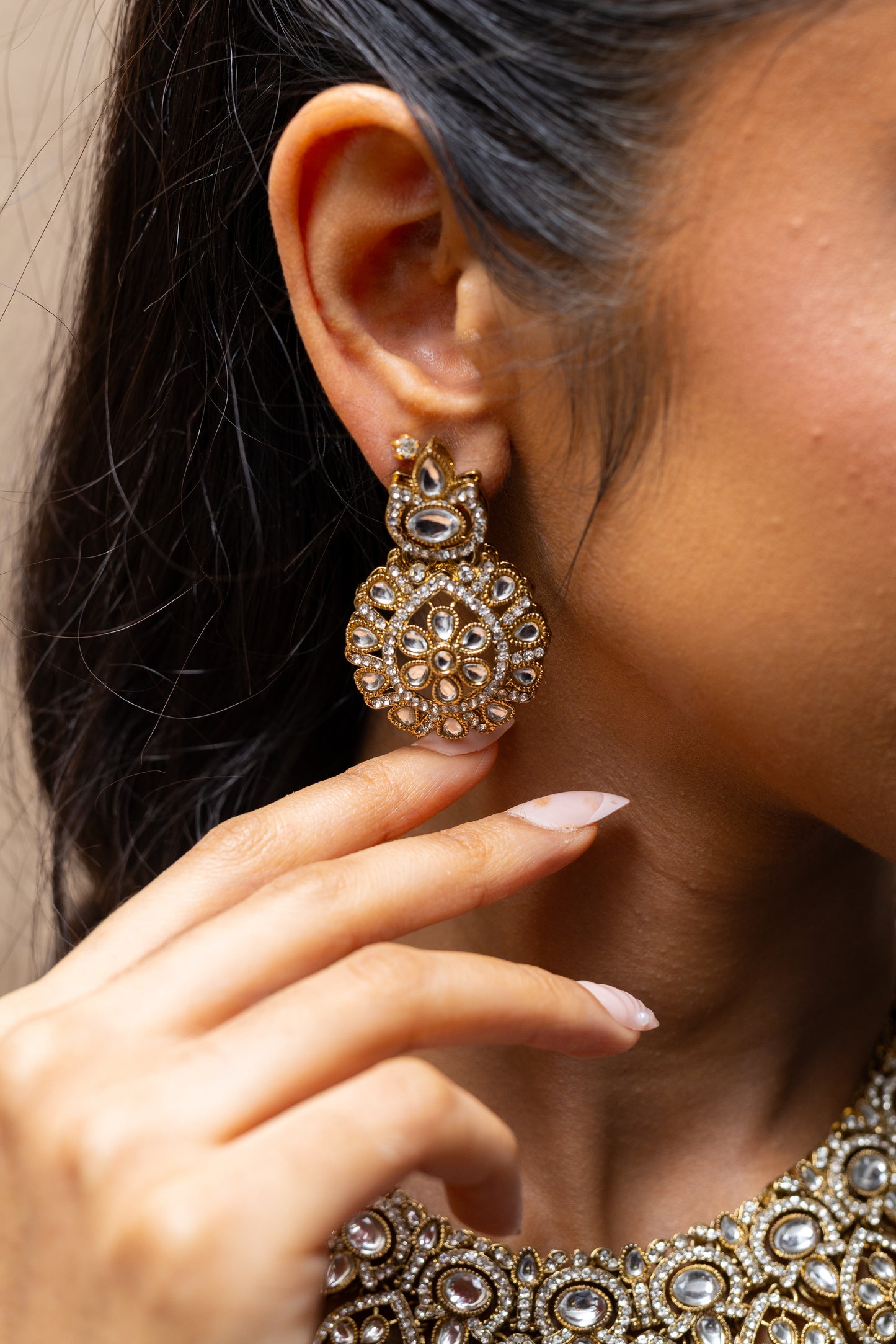 Innaya Kundan Jewellery Set paired with a Wine colour Saree — Classic elegant statement for wedding guests and pre-wedding events. Close up earings