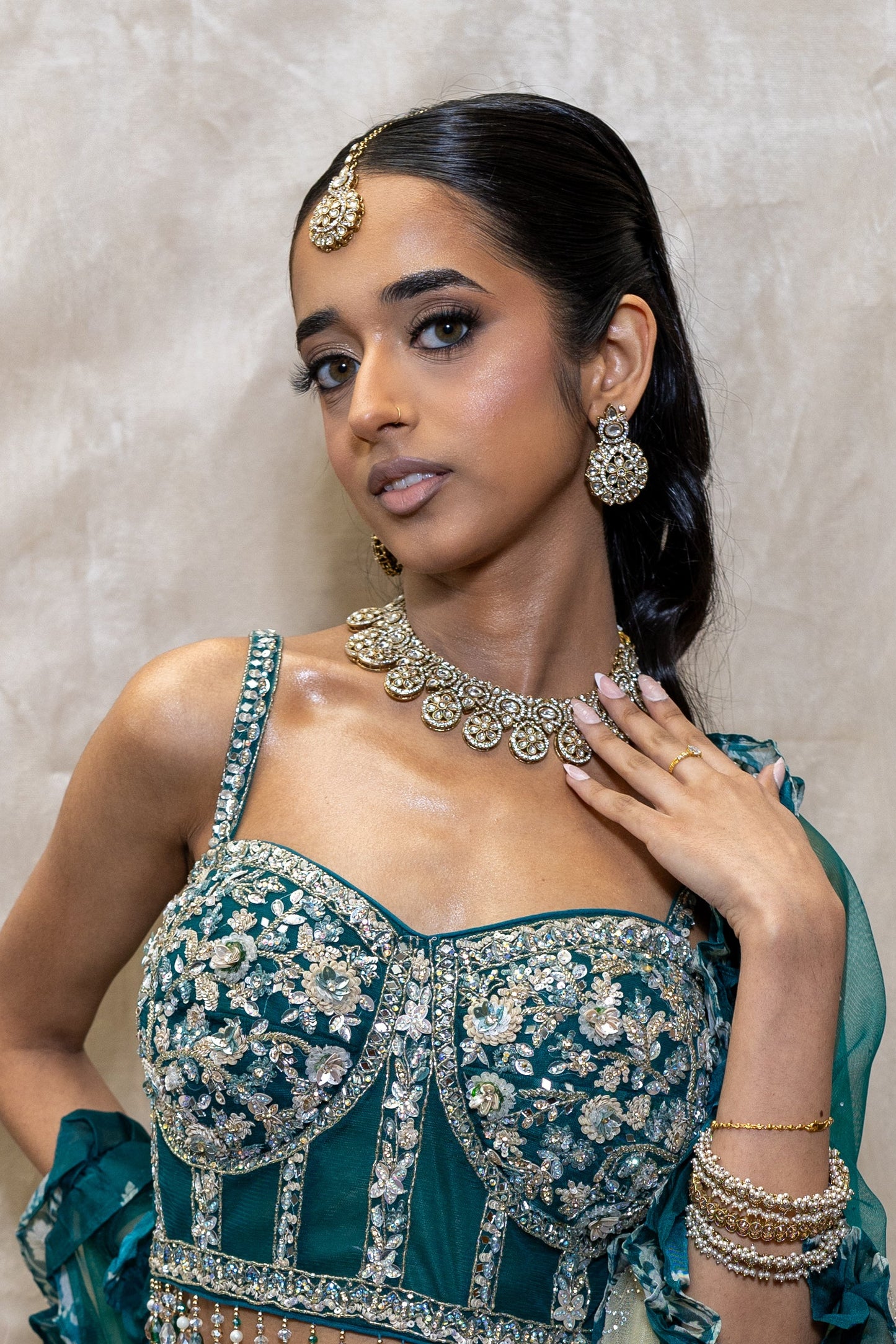 Innaya Kundan Necklace and Tikka Set styled with a dark bluey-green Lehenga — Sophisticated South Asian bridal look curated in London.