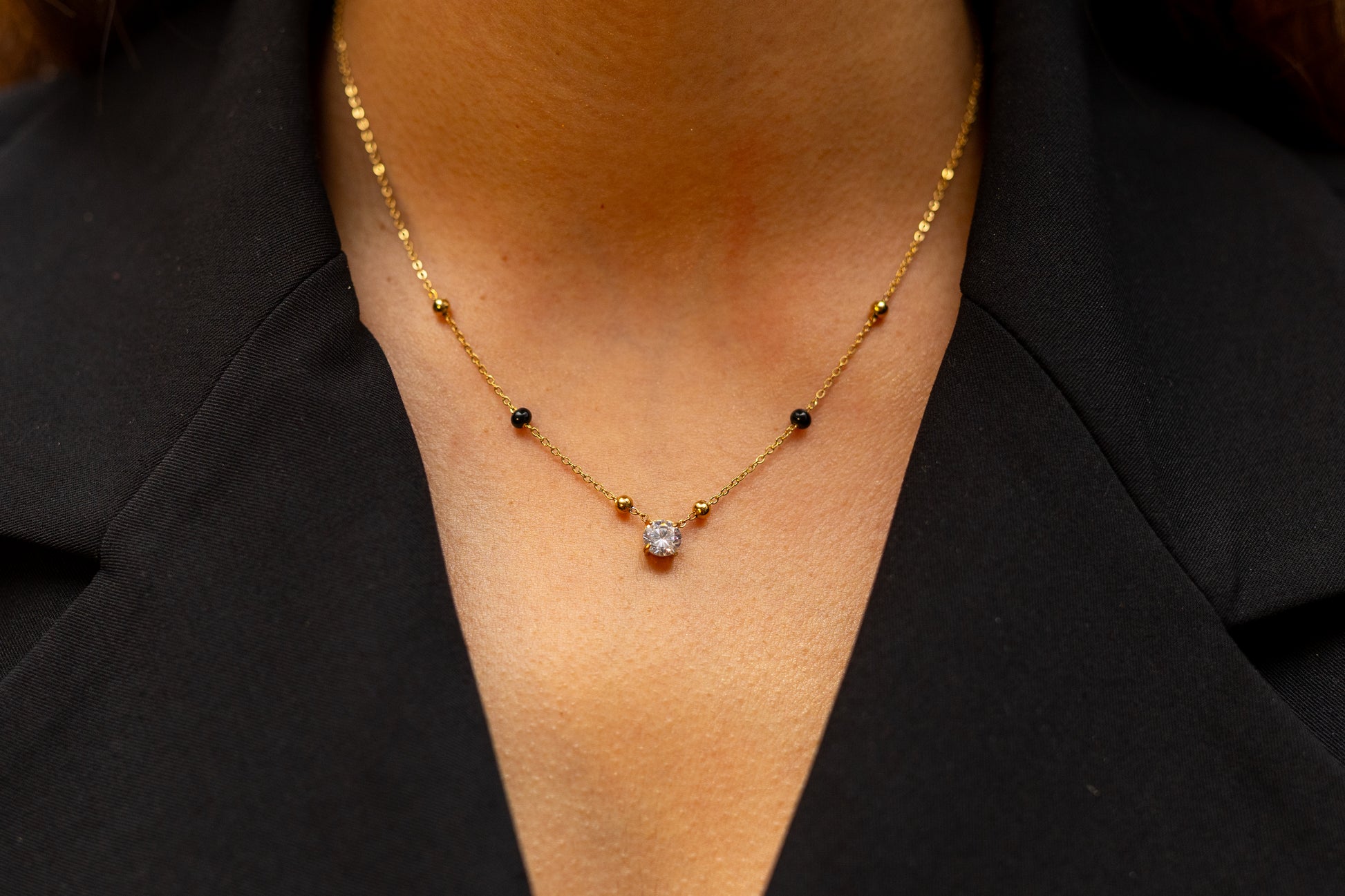 Close-up of Avira Necklace Gold Chain and Symbolic Black Beads - Minimalist South Asian Inspired Everyday Jewellery - Hypoallergenic Finish.