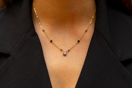 Close-up of Avira Necklace Gold Chain and Symbolic Black Beads - Minimalist South Asian Inspired Everyday Jewellery - Hypoallergenic Finish.