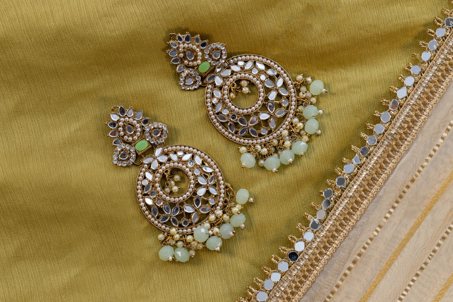 Close-up of Myra Earrings featuring Intricate Kundan Floral Motifs and Pastel Mint Green Drops - Premium Bridal and Festive Accessories.